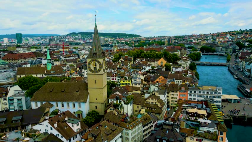 4K Drone Video of the Historic Fraumünster and St. Peter Churches on the banks of the Limmat River in Downtown Zurich, Switzerland