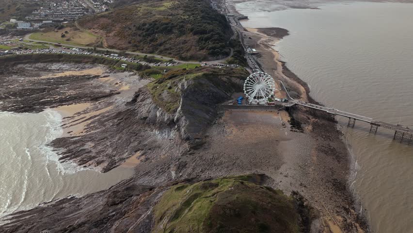Dramatic view of The Big Wheel at Mumbles Pier Swansea in England. Aerial shot.