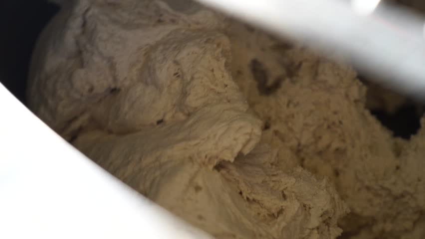 Dough being mixed in a bakery for sourdough bread preparation