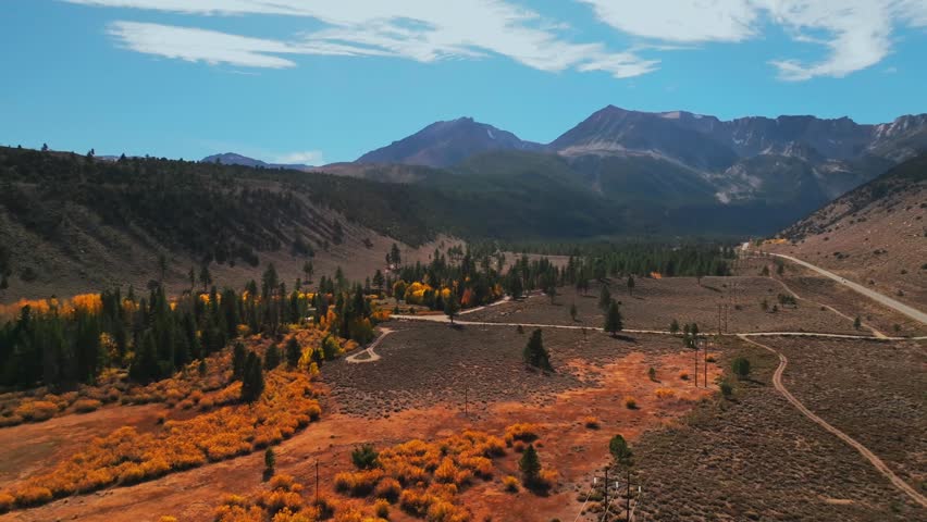 West Portal Entrance Lee Vining Tioga Pass Road Yosemite National Park Ansel Adams Wilderness Big Oak Flat California aerial drone fall autumn yellow orange Aspen Trees blue skies clouds cars circle