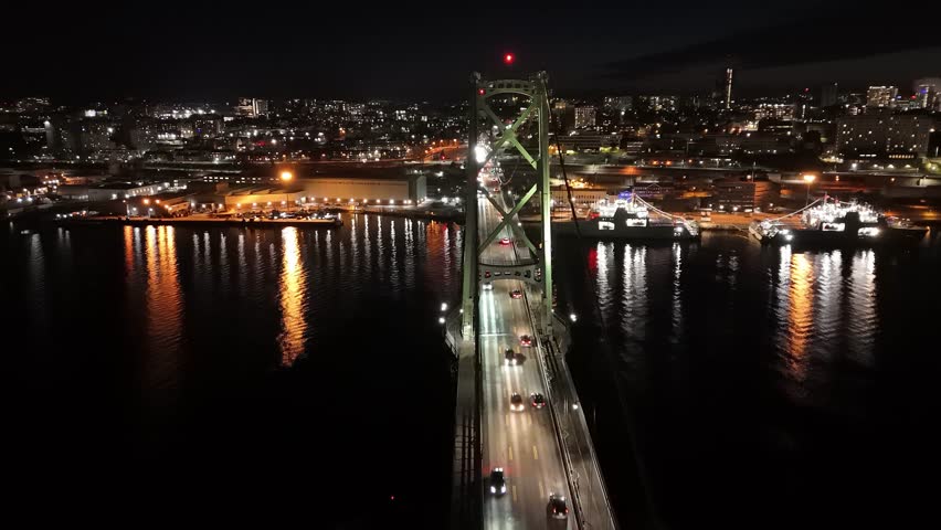 Cinematic Drone Footage Capturing The Beauty Of A Night Bridge In Halifax. Cars Drive Across, Illuminating The Scene With Their Lights, Creating A Vibrant View Of The Halifax-Dartmouth Connection.