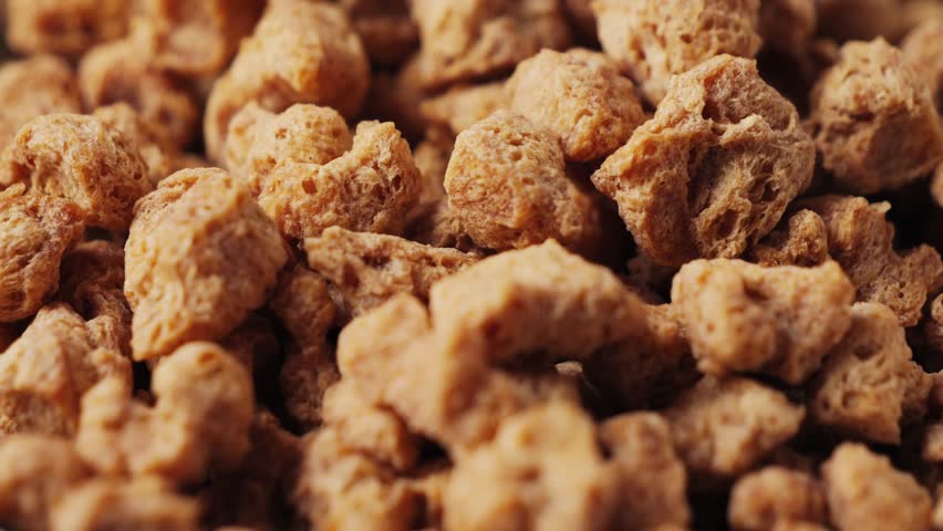 Dried soy meat pieces in a bowl with species. Textured vegetable protein. Healthy eating. Vegan food. High quality 4k footage