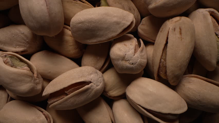 Healthy unpeeled pistachios nuts in shells,macro dolly. Fresh harvest,energy eat