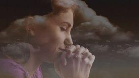 Praying with hands clasped, woman with clouds and cross in background animation. Spiritual, faith, worship, devotion, serenity, religious - Powered by Shutterstock - Get 15% off with code: PIKWIZARD15