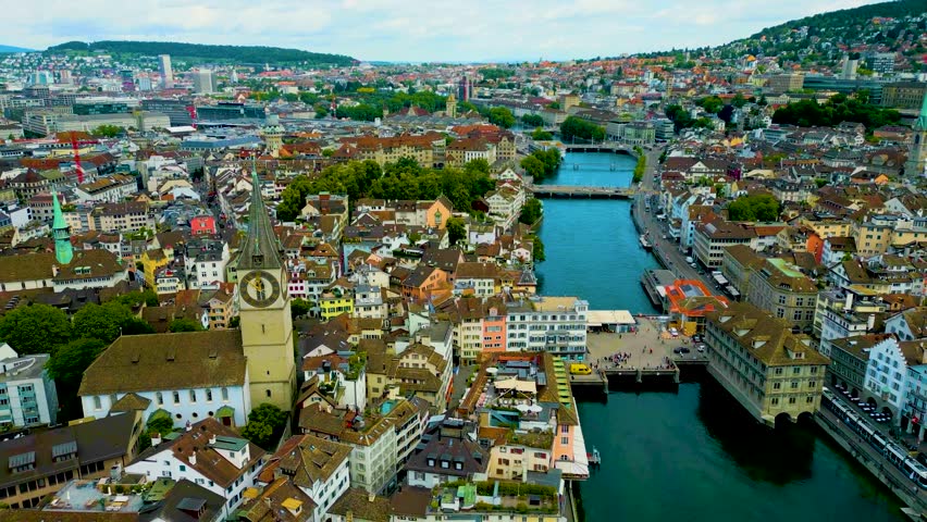 4K Drone Video of the Historic St. Peter Church on the banks of the Limmat River in Downtown Zurich, Switzerland