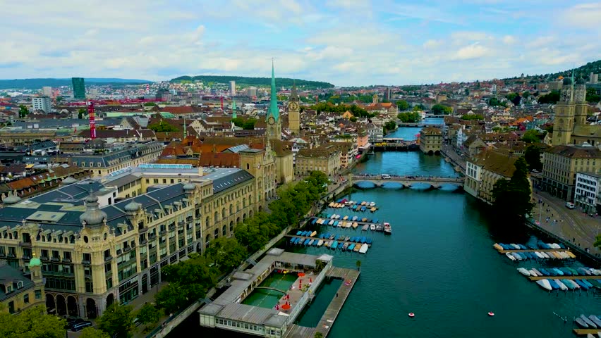 4K Drone Video of the Historic Fraumünster and St. Peter Churches on the banks of the Limmat River in Downtown Zurich, Switzerland (High Speed)