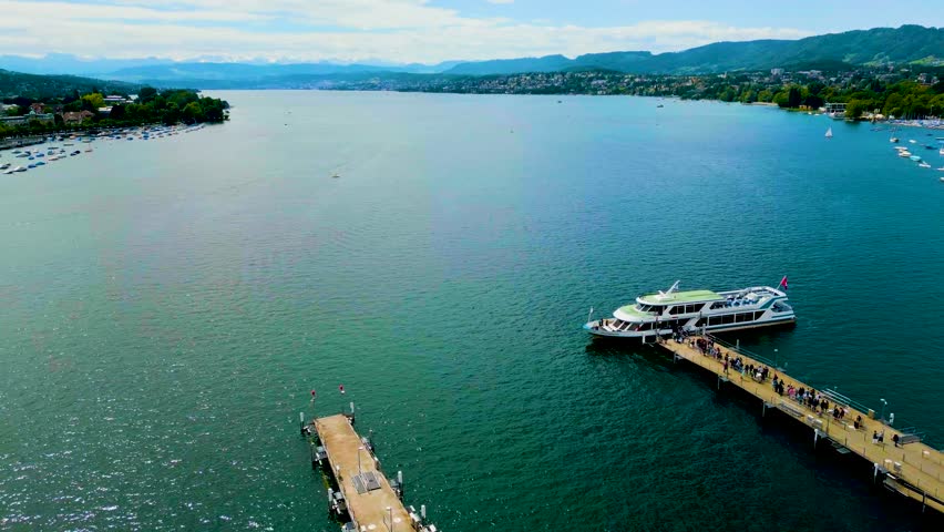 4K Drone Video of Passengers Loading onto Tour Boat Docked on Lake Zurich in Downtown Zurich, Switzerland