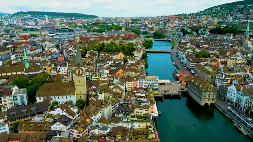4K Drone Video of the Historic Predigerkirche and St. Peter Churches on the banks of the Limmat River in Downtown Zurich, Switzerland
