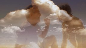 On beach, elderly couple watching animation of fluffy clouds in sky. Seniors, leisure, relaxing, vacation, sunset, retired - Powered by Shutterstock - Get 15% off with code: PIKWIZARD15