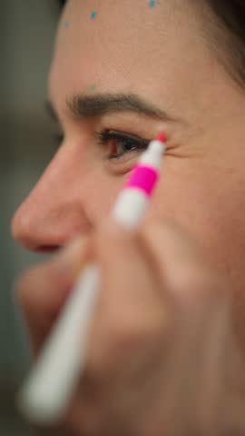 Portrait of a beautician drawing on a face with a marker. Cosmetic surgery is changing the appearance of a person's face. High quality 4k footage