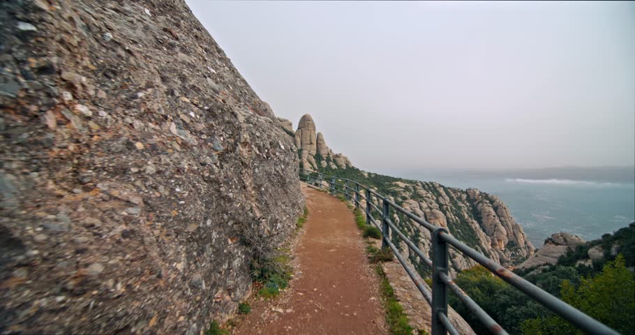 Hiking on the paths to the Montserrat mountain in Barcelona. Active recreation in the mountains of Catalonia, hiking in the mountains. High quality 4k footage