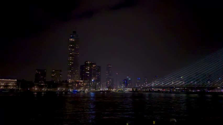 Rotterdam skyline view over the Maas river. Erasmus bridge at night.