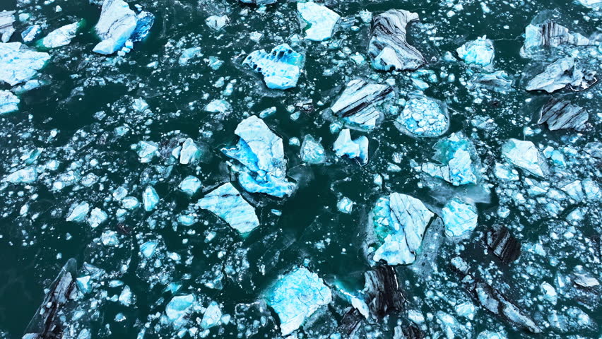 Iceberg in the ocean, Huge chunks of blue glacier Ice floating on the waves, Arctic Nature in Iceland