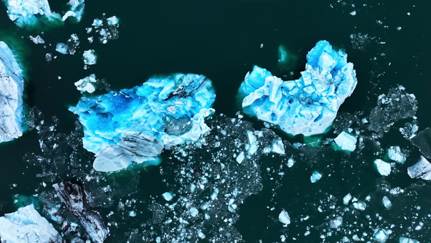 Iceberg in the ocean, Huge chunks of blue glacier Ice floating on the waves, Arctic Nature in Iceland