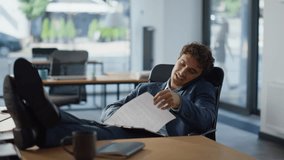 Multitasking manager talking call feeling relaxed in panoramic office closeup. Happy businessman cellphone conversation looking documents in workplace. Positive man analyzing paperwork at phone talk - Powered by Shutterstock - Get 15% off with code: PIKWIZARD15