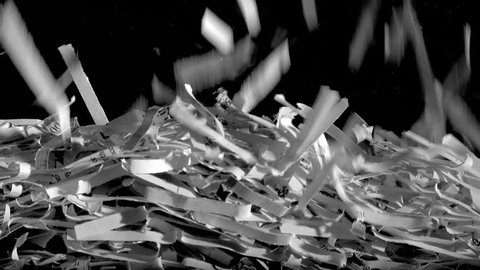 Papers scraps falling from a shredder gradually fill up the screen.
