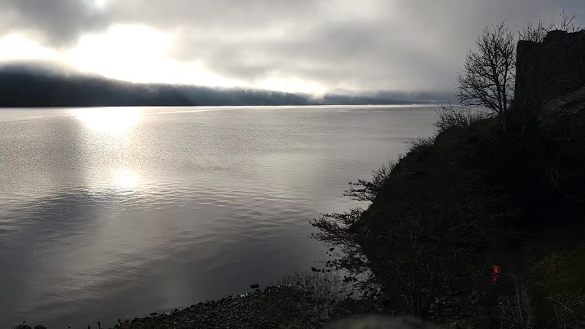 A misty loch reflects the sun