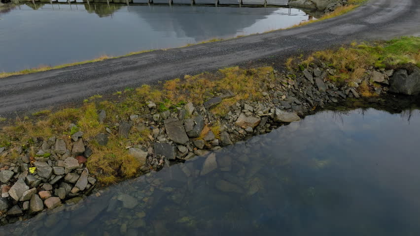 Person crossing Hammerskaft bridge in Reine village, Lofoten, Norway
