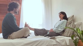 Caring man giving relaxing foot massage to woman on bed - Powered by Shutterstock - Get 15% off with code: PIKWIZARD15