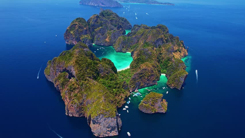Amazing aerial view of Phi Phi Leh with paradise beach on Maya Bay in Krabi. Touristic tropical landmark of Thailand, travel video by drone.