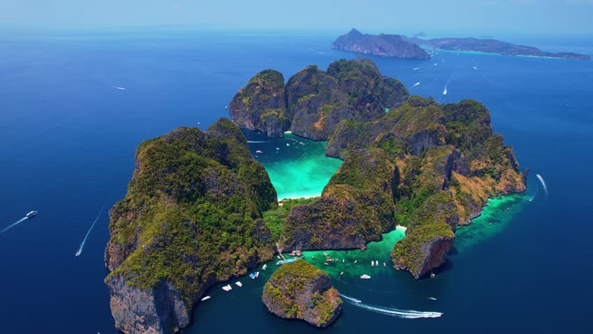Lagoon Maya Bay , island Ko Phi Phi Leh, Thailand, aerial top view sunset. Amazing drone travel video of turquoise water and white beach.