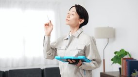 A female worker inspecting a room while looking at a tablet - Powered by Shutterstock - Get 15% off with code: PIKWIZARD15