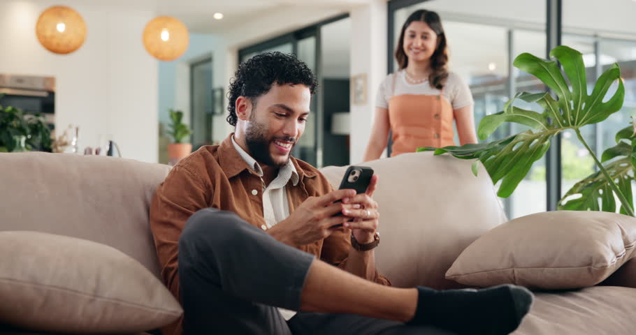 Happy couple hug, talking and mobile in home for wow, online shopping or surprise purchase for sale. Man, woman and typing on phone on sofa to relax for streaming service, social media or show video