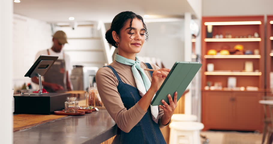 Business owner, woman and writing on tablet in coffee shop for inventory management, menu planning or client review. Hospitality, startup and digital app in cafe for stock checklist and online order