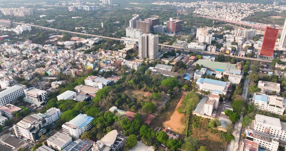 Aerial drone footage showcasing an industrial area with large infrastructure buildings, warehouses, and factories, highlighting urban development and commercial expansion
