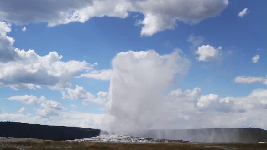 Old Faithful geyser erupts at Yellowstone Park, Wyoming, USA.