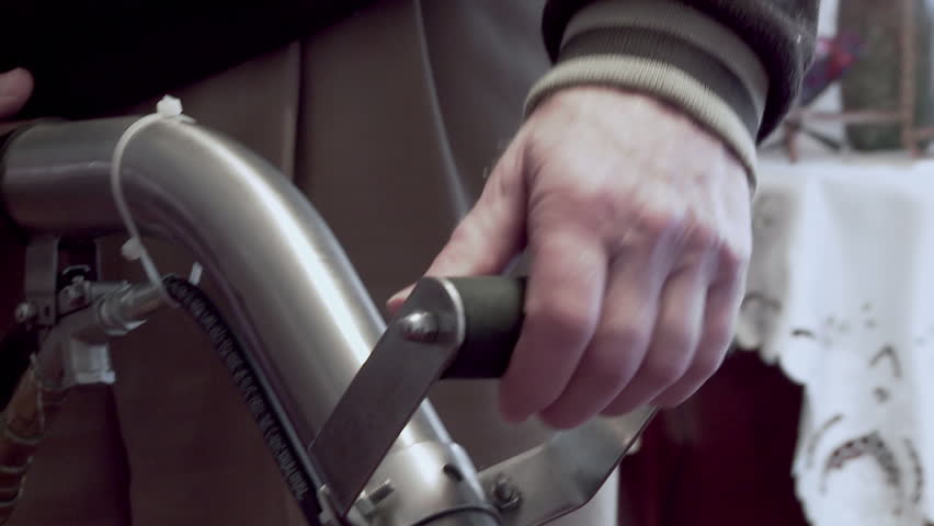 Cleaning a carpet with a steam wand, close up of hands operating the equipment.