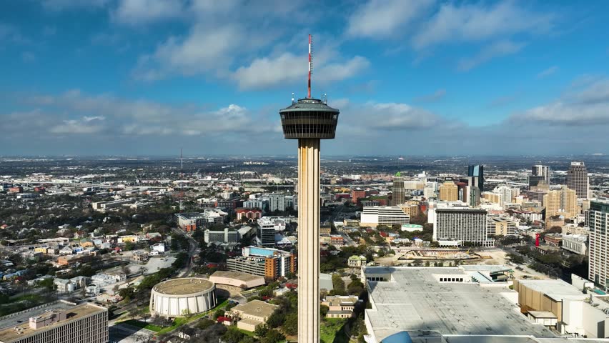 Drone rising around the Tower of the Americas, sunny day in San Antonio, TX, USA