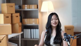 Online seller carefully packaging orders while recording marketing content, showcasing entrepreneurial workflow for social media promotion and small business growth - Powered by Shutterstock - Get 15% off with code: PIKWIZARD15