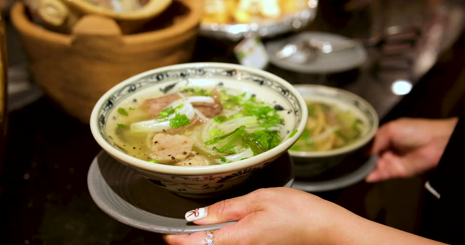 Vietnamese Pho Soup Traditional Vietnamese pho soup with beef slices, noodles, and fresh herbs in a bowl, Vietnamese cuisine concept