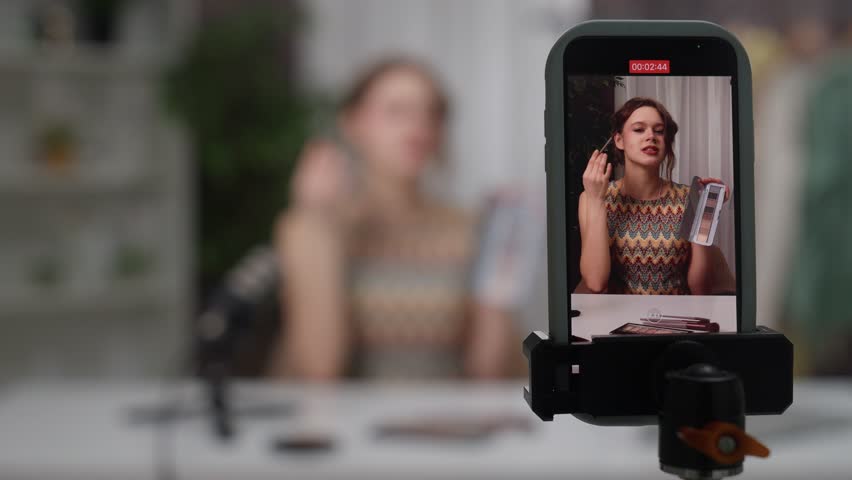 Blogger Records Expert Fashion and Beauty Tips in a Stylish Studio Environment