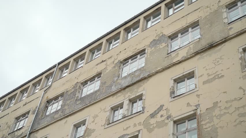 Old building with peeling paint and cracked walls