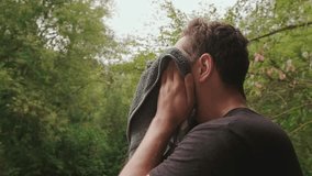 Tired man after marathon run wipes sweat from his face with a towel, promoting an active lifestyle for youth and health. - Powered by Shutterstock - Get 15% off with code: PIKWIZARD15