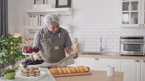 Happy Senior Asian couple doing sweet food at home - Powered by Shutterstock - Get 15% off with code: PIKWIZARD15