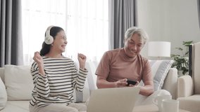 Senior Asian couple enjoy to listen music at home - Powered by Shutterstock - Get 15% off with code: PIKWIZARD15