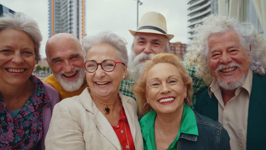Group of happy elderly people bonding outdoors  - Old people in the age of 60, 70, 80 having fun and spending time together, concepts about elderly, seniority and wellness aging