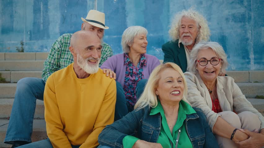 Group of happy elderly people bonding outdoors  - Old people in the age of 60, 70, 80 having fun and spending time together, concepts about elderly, seniority and wellness aging