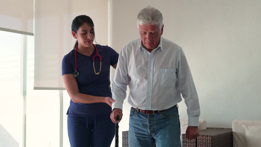 Professional nurse helps senior man with mobility issues, providing support and care