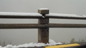 A close-up shot of a concrete fence post partially covered in snow, set against a misty backdrop. - Powered by Shutterstock - Get 15% off with code: PIKWIZARD15