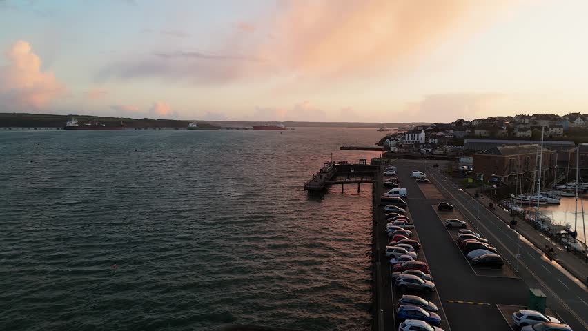 Milford waterfront, showcasing the water, boats, and nearby buildings at sunset, aerial view