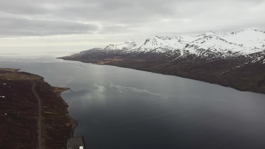 Serene Icelandic landscape showcasing a vast fjord and rugged mountain terrain