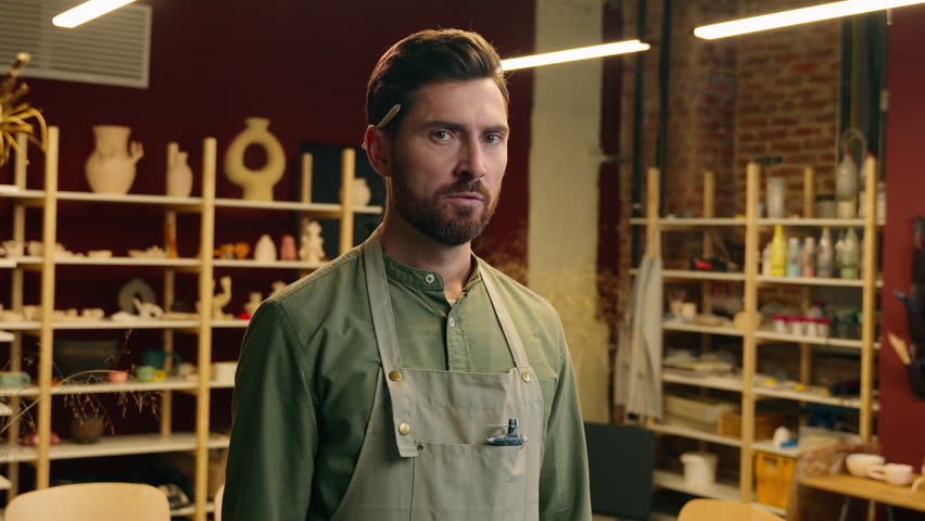 Angry mad furious Caucasian man male guy small business owner businessman potter seller salesman craftsman pointing index finger looking at camera gesture you rage anger screaming shout indoors store