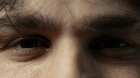 A close-up of a man's intense eyes with furrowed brows, conveying focus or determination - Powered by Shutterstock - Get 15% off with code: PIKWIZARD15