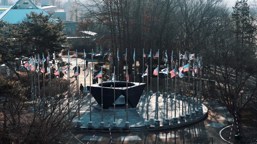 Numerous US and South Korean flags near the DMZ, symbolizing the strong alliance, shared commitment to security, and ongoing efforts for peace on the Korean Peninsula