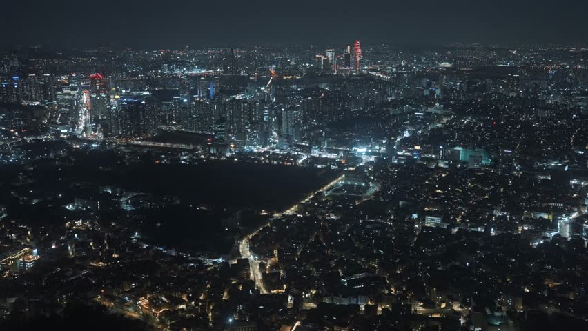 Stunning aerial night view of Seoul, South Korea, captured from N Seoul Tower, showcasing the illuminated cityscape, modern skyscrapers, and vibrant urban life
