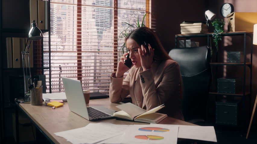 Frustrated tired stressed Caucasian businesswoman female girl business woman office worker employee crisis burnout multitasking deadline work computer laptop paperwork graph talking smartphone indoors - Powered by Shutterstock - Get 15% off with code: PIKWIZARD15